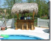 Add to your Tiki bar decor with this thatched tiki hut by your pool.